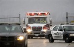 Police vehicles escort the ambulance carrying Dr. Martin Salia, a surgeon working in Sierra Leone who had been diagnosed with Ebola