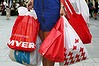 Woman loaded down with shopping bags.