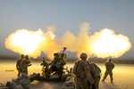 File - Soldiers serving with Alpha Battery, 2nd Battalion, 77th Field Artillery Regiment, 4th Infantry Brigade Combat Team, 4th Inf. Division, shoot a round down range from their M777A2 howitzer on Kandahar Airfield, Afghanistan, Aug. 22, 2014.