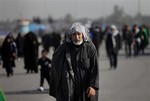 File - Shiite faithful pilgrims march to Karbala for Arbaeen in Baghdad's southern district of Dora, Thursday, Dec. 19, 2013. The holiday marks the end of the 40-day mourning period after the anniversary of the 7th century martyrdom of Imam Hussein the Prophet Muhammad's grandson.