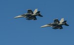 Two EA-18G Growlers fly in formation before landing on the flight deck of the Nimitz-class aircraft carrier USS Carl Vinson as the ship conducts flight operations in the U.S. 5th Fleet area of responsibility supporting Operation Inherent Resolve, Arabian Gulf, 19 November, 2014, supporting maritime security operations and strike operations in Iraq and Syria as directed.