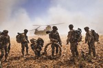 File - Soldiers of the 82nd Airborne Division gather their equipment before boarding a CH-47F Chinook that serves with the Task Force Flying Dragons, or 1st General Support Aviation Battalion., 25th Avn. Regiment, 16th Combat Avn. Brigade, in the Nawa Valley, Kandahar Province, Afghanistan, May 25, 2014.