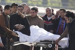 Former Egyptian President Hosni Mubarak, 86, greets medics, army personnel and his supporters, as he leaves a helicopter ambulance after it landed at Maadi Military Hospital following his verdict in Cairo, Egypt, Saturday, Nov. 29, 2014.