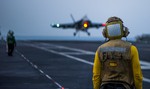 Aviation Boatswain's Mate (Handling) 2nd Class Ted Casal monitors the flight deck of the Nimitz-class aircraft carrier USS Carl Vinson (CVN 70) as the ship conducts flight operations in the U.S. 5th Fleet area of responsibilityin the Arabian Gulf supporting Operation Inherent Resolve, conducting strike operations in Iraq and Syria as directed, 22 November, 2014.