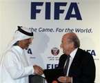 In this Thursday, Dec. 16, 2013 file photo, FIFA president Sepp Blatter, right, and Qatar Football Association (QFA) President Sheik Hamad Bin Khalifa Bin Ahmed al-Thani exchange documents after officially appointing Qatar as the host of the 2022 FIFA World Cup, in Doha, Qatar.