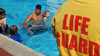 Lifeguard keeping watch over swimmers in pool