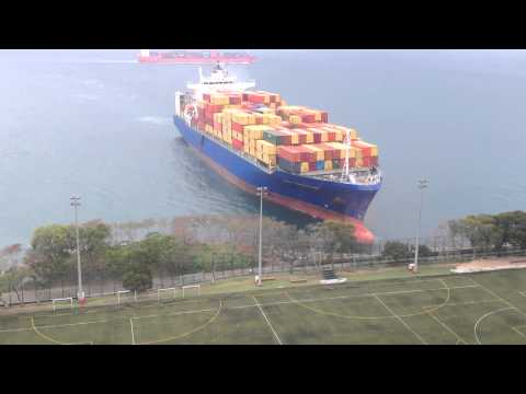 Container ship sails straight to shore by university football field