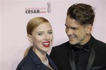 Scarlett Johansson, left, and her partner Romain Dauriac arrive at the 39th French Cesar Awards Ceremony