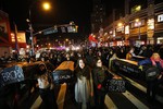 Avenue and Atlantic Avenue near the Barclays Center, Thursday, Dec. 4, 2014, in the Brooklyn borough of New York. A grand jury cleared a white New York City police officer Wednesday in the videotaped chokehold death of Garner, an unarmed black man, who had been stopped on suspicion of selling loose, untaxed cigarettes.