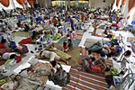 Hundreds of residents take shelter inside the provincial capitol of Surigao city close to central Philippines on Friday, Dec. 5, 2014 in anticipation of typhoon Hagupit which is expected to hit land Saturday afternoon.