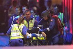 Emergency personnel wheel an injured hostage to an ambulance during a cafe siege in the central business district of Sydney , Australia, Tuesday, Dec. 16, 2014.