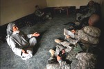 File - An elderly Iraqi man explains his community's situation to Soldiers in the city of Abu T-Shir, Iraq, Oct. 16, 2008.