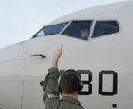 File - Naval Aircrewman (Operator) 3rd Class Michael Herman gives the thumbs up to Lt. j.g.  Tyler Terronez, both assigned to Patrol Squadron (VP) 16, during preflight checks on a P-8A Poseidon prior to going on a search mission in support of the international effort to locate Malaysia Airlines flight MH370, Perth, Australia, April 8, 2014.