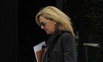 FILE - In this April 5, 2013 file photo, Spain's Princess Cristina walks towards her office in Barcelona, Spain. A Spanish court has subpoenaed Princess Cristina, the daughter of Spain's King Juan Carlos, as a suspect of tax fraud and money laundering, the latest blow to the royal family's reputation. Palma de Mallorca court judge Jose Castro on Tuesday, Jan. 7, 2014 ordered the 48-year-old princess to appear March 8 for questioning concerning investments and finances relating to her partnership with her husband Inaki Urdangarin in a firm called Aizoon.