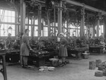 Women war workers sawing wood specimens for testing at the New Gun Factory, Woolwich Arsenal, London, during World War I.