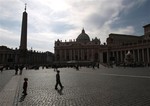 People walk in front of St. Peter Basilica at The Vatican Friday April 9, 2010