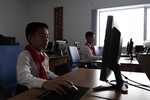 In this June 11, 2013 photo, students attend their computer lesson at the Pyongyang International Football School which opened on May 31, 2013 on Rungna Island