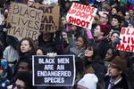 Demonstrators march in New York, Saturday, Dec. 13, 2014, during the Justice for All rally and march. In the past three weeks, grand juries have decided not to indict officers in the chokehold death of Eric Garner in New York and the fatal shooting of Michael Brown in Ferguson, Mo.