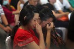 Relatives and next-of-kin of passengers on the AirAsia flight QZ8501 wait, some in tears while others in prayer, for the latest news on the search of the missing jetliner at Juanda International Airport in Surabaya, East Java, Indonesia, Monday, Dec. 29, 2014. Search planes and ships from several countries on Monday were scouring Indonesian waters over which an AirAsia jet disappeared, more than a day into the region's latest aviation mystery. AirAsia Flight 8501 vanished Sunday in airspace thick with storm clouds on its way from Surabaya, Indonesia, to Singapore.