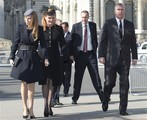 File - Prince Andrew, right, with his former wife Sarah Ferguson and their daughter Princess Beatrice arrive for the Sir David Frost memorial service at Westminster Abbey in London, Thursday March 13, 2014