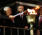 Palestinian President Mahmoud Abbas lights a torch during a rally.