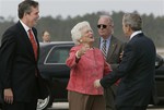 File - President Bush is welcomed by is mother, former first lady Barbara Bush, and his brother, Florida Gov. Jeb Bush, left, as he arrives at the Pensacola Naval Air Station in Pensalcola, Fla., to begin a day of events promoting his Social Security reforms, Friday, March 18, 2005.