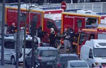 A security officer directs released hostages after they stormed a kosher market to end a hostage situation, Paris, Friday, Jan. 9, 2015.