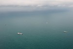 A multinational grouping of naval vessels participates in search operations at the location of AirAsia Flight QZ8501's tail in the Java Sea, 7 January, 2014.