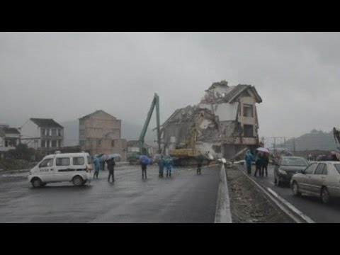 Chinese house in middle of road demolished