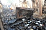 File - People inspect damaged shops following a Monday bomb explosion at a Market in Bauchi, Nigeria. Tuesday. Dec. 23, 2014.