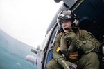 Naval Aircrewman 1st Class Joseph Jiardina, assigned to Helicopter Maritime Strike Squadron 35, searches for debris in support of the Indonesian-led AirAsia flight QZ8501 search efforts over the Java Sea, 6 January, 2015.