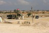 Palestinian Hamas security stand guard near an Egyptian watch tower on the border with Egypt in Rafah, southern Gaza Strip, on July 5, 2013. Egyptian official said the country's border crossing with Gaza Strip in northern Sinai has been closed indefinitely, citing security concerns. The decision comes hours after suspected Islamic militants attacked four sites in northern Sinai and Egyptian soldier was killed early today, targeting two military checkpoints, a police station and el-Arish airport, where military aircraft are stationed. Photo by Ahmed Deeb /  WN