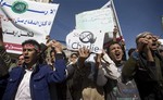 Yemenis chant slogans during a protest against caricatures published in French magazine Charlie Hebdo in front of the French Embassy in Sanaa, Yemen, Saturday, Jan. 17, 2015.