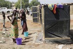 File - Civilians who fled their homes following an attack by Islamist militants, in North East Nigeria wait to use the wash room at the camp for internally displaced people in Yola, Nigeria, Thursday Nov. 27, 2014.