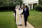 File - President Barack Obama walks with King Abdullah of Saudi Arabia, and members of the Saudi delegation, towards the South Lawn Driveway, prior to the King's departure from the White House, June 29, 2010.