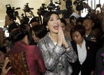 Thailand's former Prime Minister Yingluck Shinawatra, center, leaves parliament in Bangkok, Thailand, Thursday, Jan. 22, 2015.