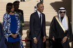 President Barack Obama and first lady Michelle Obama stand with new Saudi King Salman bin Abdul Aziz for a receiving line as they arrive at King Khalid International Airport, in Riyadh, Saudi Arabia, Tuesday, Jan. 27, 2015.