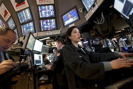 Trader Tina Vlitas with Kellogg Capital Markets speaks with fellow traders on the floor of the New York Stock Exchange, Wednesday, March 31, 2010