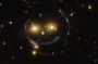 INTERGALACTIC EMOTICON: In the centre of this image, taken with the Hubble Space Telescope, is the galaxy cluster SDSS J1038+4849  and it seems to be smiling.