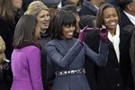 First Lady Michelle waves across the aisle at the ceremonial swearing-in for President Barack Obama at the U.S. Capitol during the 57th Presidential Inauguration in Washington, Monday, Jan. 21, 2013.