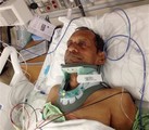 In this Saturday, Feb. 7, 2015 photo released by Chirag Patel,  Sureshbhai Patel is shown in a bed at Huntsville Hospital in Huntsville, Ala. An officer with the Madison Police Department has been arrested and faces termination following a confrontation in which the 57-year-old Indian grandfather was injured.