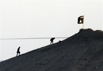 In this image shot with an extreme telephoto lens and through haze from the outskirts of Suruc at the Turkey-Syria border, militants with the Islamic State group are seen after placing their group's flag on a hilltop at the eastern side of the town of Kobani, Syria, where fighting had been intensified between Syrian Kurds and the militants of Islamic State group, Monday, Oct. 6, 2014. Kobani, also known as Ayn Arab and its surrounding areas have been under attack since mid-September, with militants capturing dozens of nearby Kurdish villages.