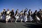 Houthi Shiite Yemenis perform a traditional dance called "Baraa" during a rally to show support for their comrades in Sanaa, Yemen, Friday, Feb. 20, 2015.