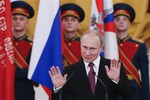 Russian President Vladimir Putin gestures at the award ceremony in St. George Hall of the Grand Kremlin Palace in Moscow, Friday, Feb. 20, 2015.