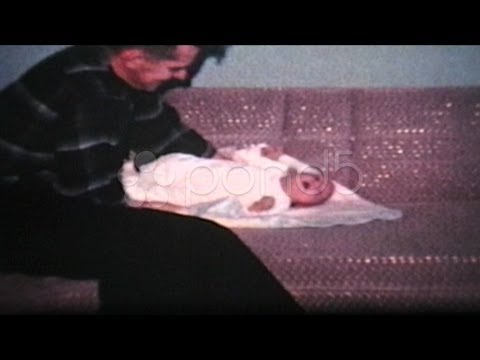 Dad Picking Up His Baby Boy (1962 - Vintage 8mm film). Stock Footage