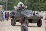 In this file photo taken Thursday, Aug. 8, 2013, a Nigerian soldier patrols in an armored car, during Eid al-Fitr celebrations, in Maiduguri, Nigeria. Graphic new video footage from northeastern Nigeria shows the country's military carrying out abuses against civilians as part of their fight against the Islamic extremists of Boko Haram, Amnesty International said Tuesday, Aug. 5, 2014.