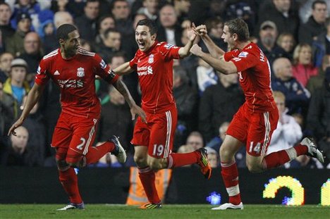 Liverpool's Glen Johnson, left, celebrates with Stewart Downing, center, and Jordan Henderson, right after scoring during the English Premier League soccer match between Chelsea and Liverpool at Stamford Bridge Stadium in London, Sunday, Nov. 20, 2011.