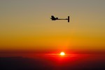 File - Solar Impulse's Chief Executive Officer and pilot Andre Borschberg flies in the solar-powered HB-SIA prototype airplane after its first night flight attempt near Payerne airport, Switzerland, as the sun rises, Thursday, July 8, 2010.