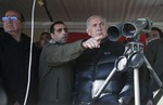 Israel's Prime Minister Benjamin Netanyahu, center, and Defense Minister Moshe Yaalon, left, stand next to Israeli soldiers at a military outpost during a visit at Mount Hermon in the Israeli-controlled Golan Heights overlooking the Israel-Syria border on Wednesday, Feb. 4, 2015.