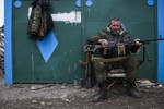 A pro-Russian rebel rests at the frontline in a illage not far from Luhasnk, eastern Ukraine, Thursday, March 12, 2015.